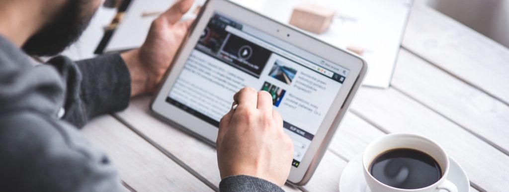 Person Browsing Internet on Tablet