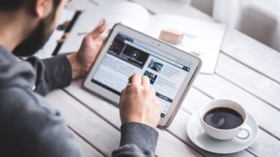 Person Browsing Internet on Tablet